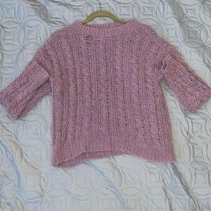 Soft pink sweater.